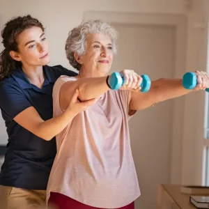 physical therapy aide helping out old lady