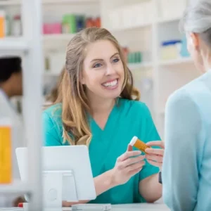pharmacy tech helping out old lady at the counter