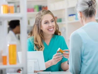 young_smiling_woman_pharmacy_technician_professional_holding_pill_bottle-1536x1024